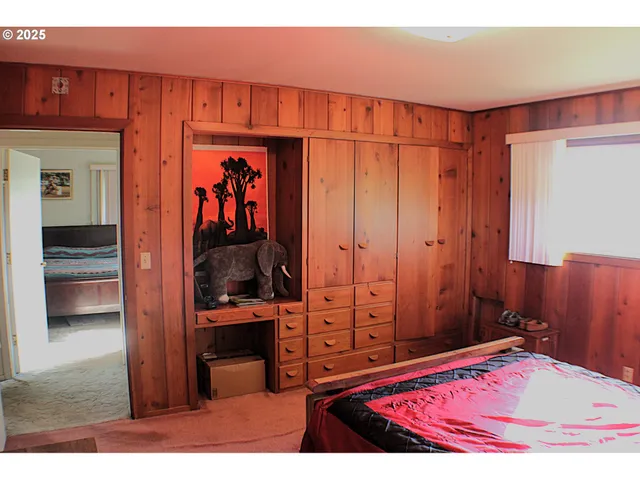 a bed sitting in a bedroom next to a window