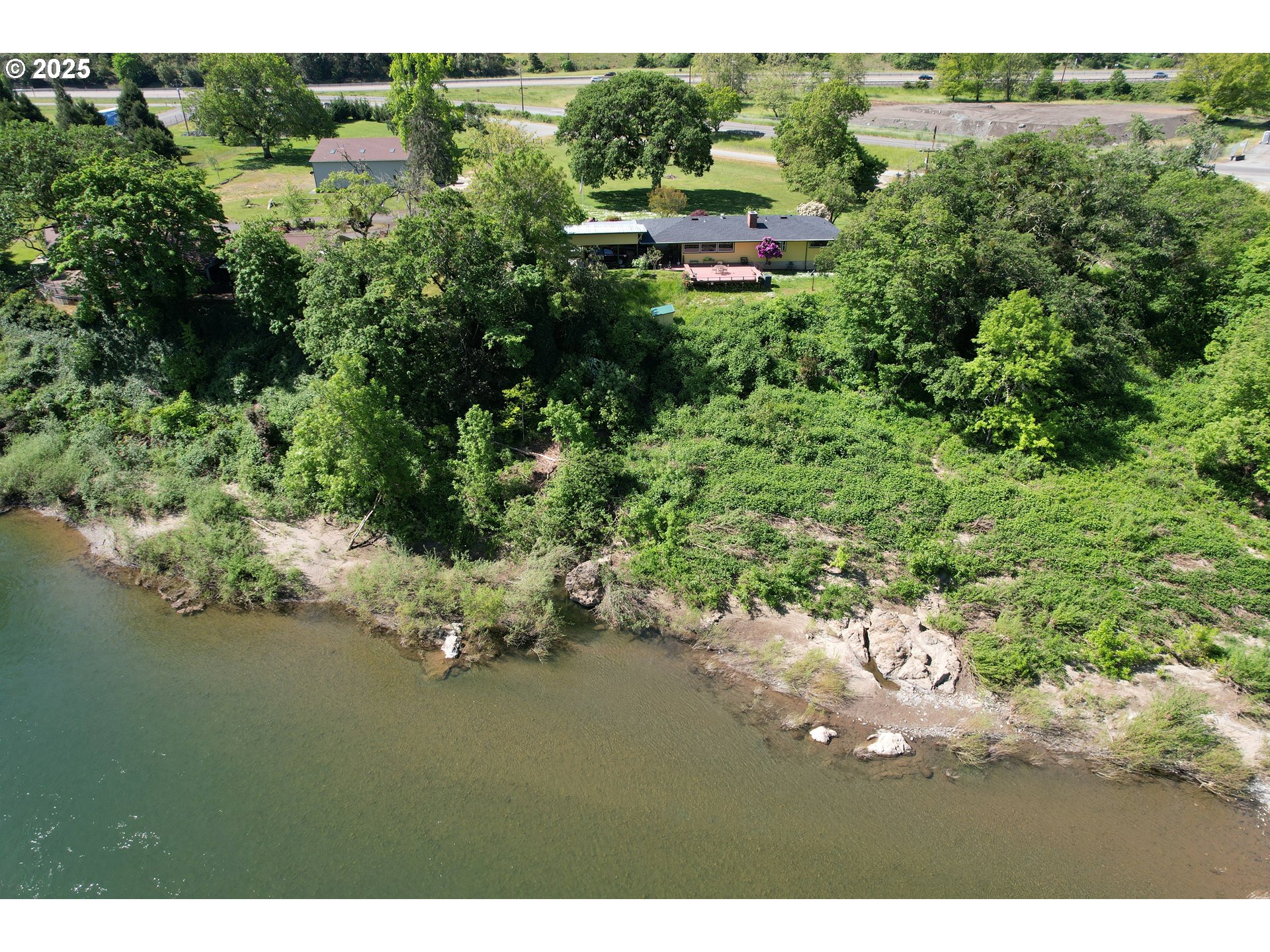 180 Ruckles Drive Myrtle Creek, OR 97457 - Photo 29 of 45 a view of a garden with a bench and trees