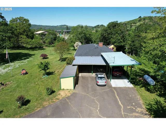 a aerial view of a house with swimming pool and green space