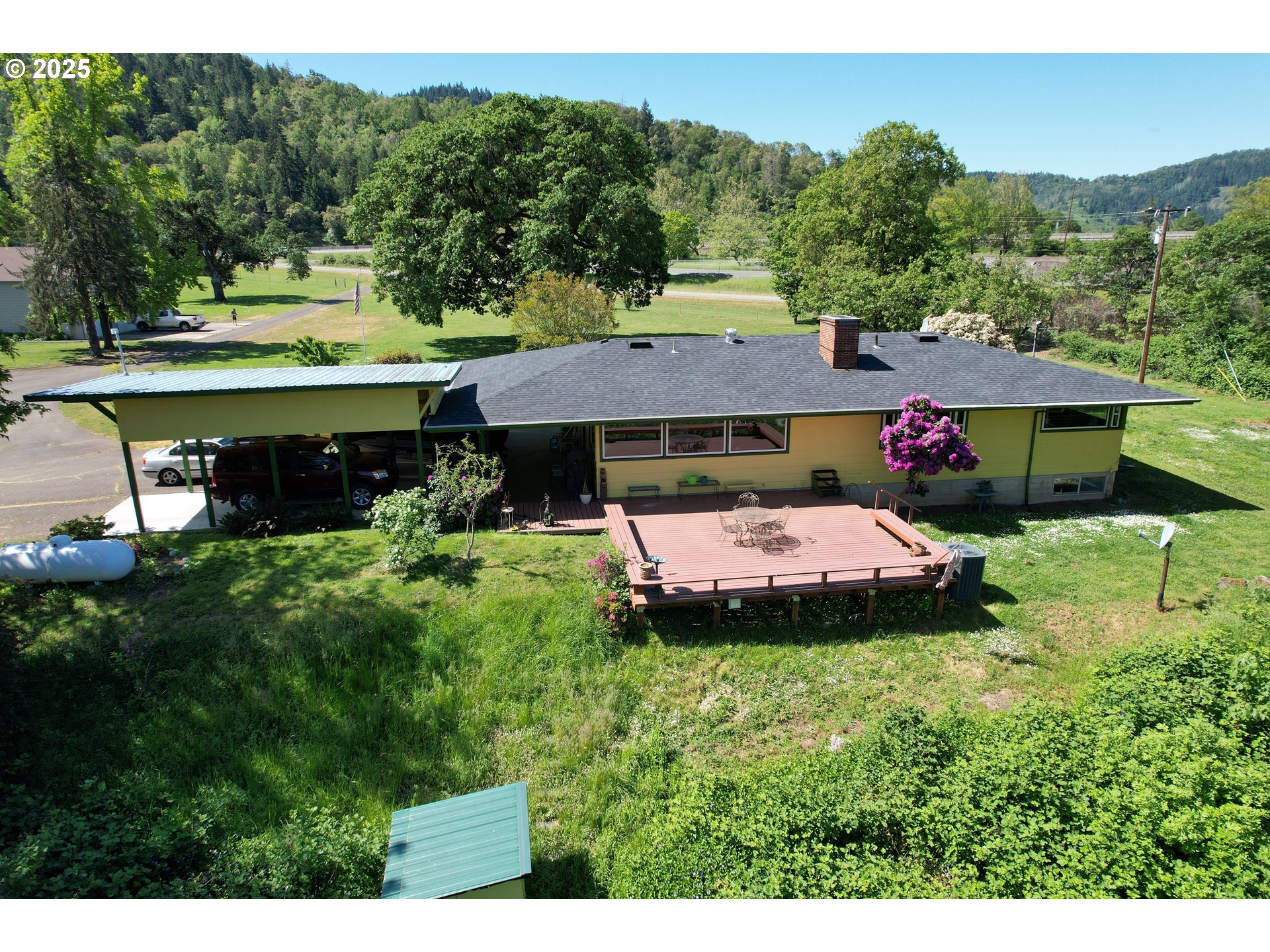 180 Ruckles Drive Myrtle Creek, OR 97457 - Photo 34 of 45 a aerial view of a house with swimming pool and green space