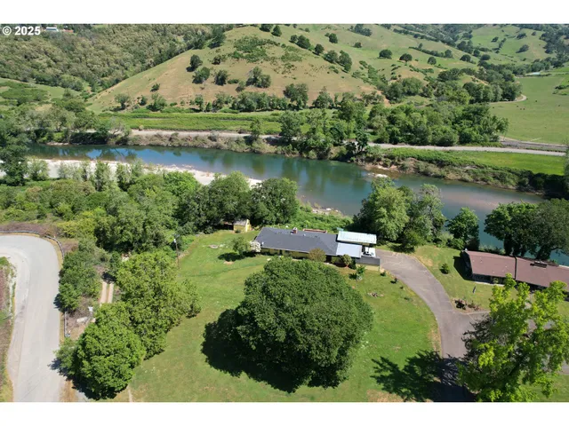 an aerial view of lake residential house with outdoor space and trees