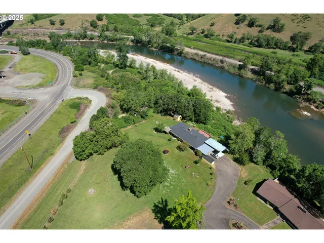 an aerial view of residential house with outdoor space and lake view