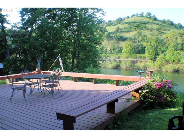 a view of a chairs and table on the wooden deck