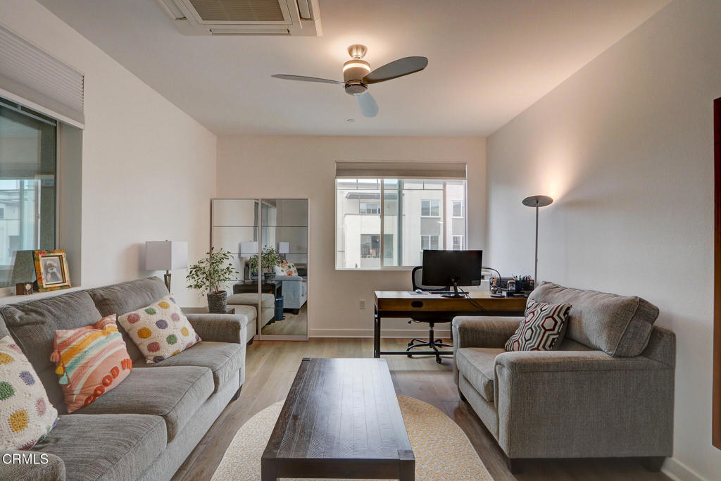 2810 Wagon Wheel Road, Unit 304 Oxnard, CA 93036 - Photo 12 of 36 a living room with furniture and a flat screen tv