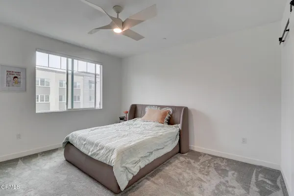 a bedroom with a bed and window