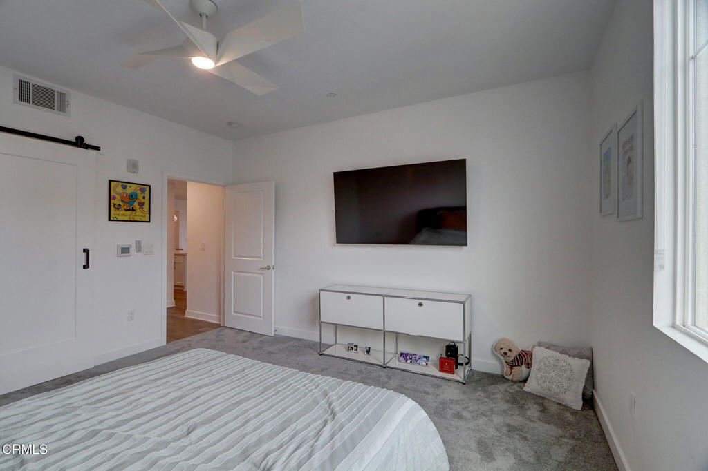 2810 Wagon Wheel Road, Unit 304 Oxnard, CA 93036 - Photo 15 of 36 a bedroom with a bed and a flat screen tv