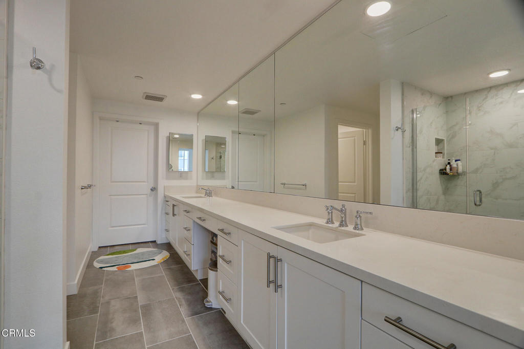 2810 Wagon Wheel Road, Unit 304 Oxnard, CA 93036 - Photo 16 of 36 a spacious bathroom with a double vanity sink mirror and