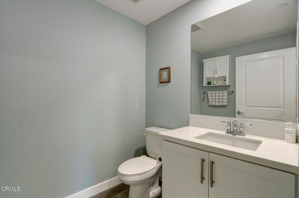 2810 Wagon Wheel Road, Unit 304 Oxnard, CA 93036 - Photo 18 of 36 a bathroom with a sink mirror and toilet