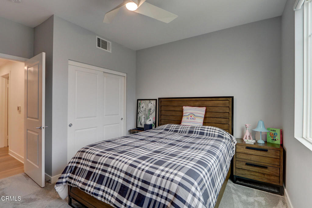 2810 Wagon Wheel Road, Unit 304 Oxnard, CA 93036 - Photo 23 of 36 a bedroom with a bed and wooden floor