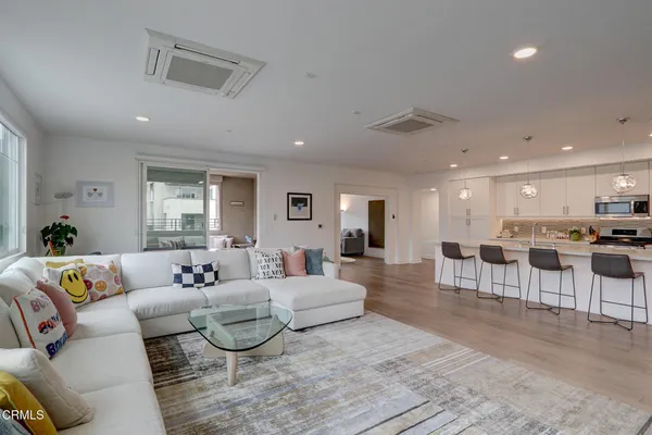 a living room with furniture and kitchen view