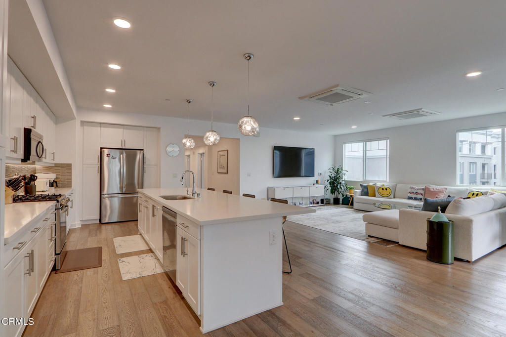 2810 Wagon Wheel Road, Unit 304 Oxnard, CA 93036 - Photo 9 of 36 a large living room with stainless steel appliances granite countertop a couch and a view of living room