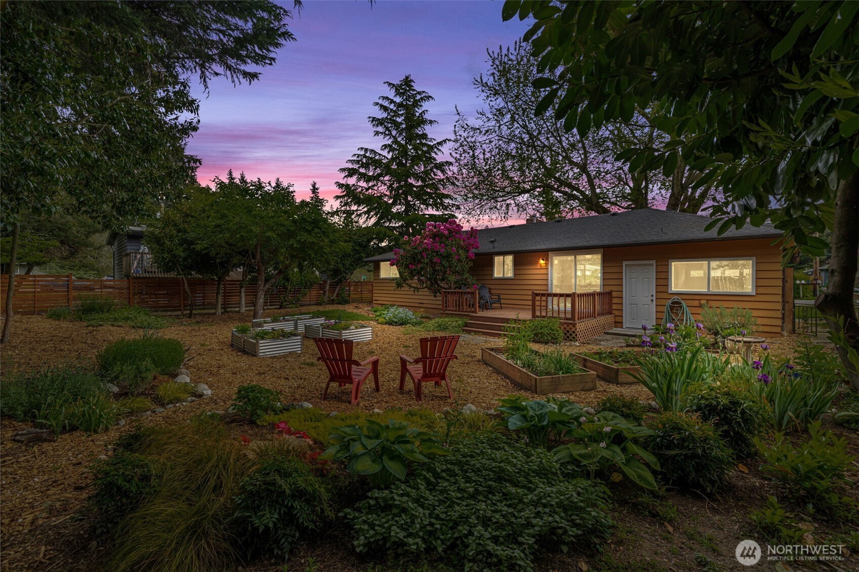 8629 223rd Street Southwest Edmonds, WA 98026 - Photo 33 of 40 a view of a patio with table and chairs and potted plants with large tree