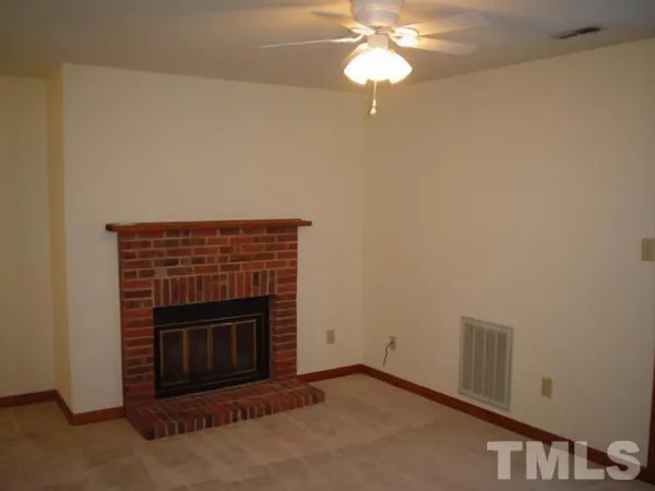 an empty room with a fireplace