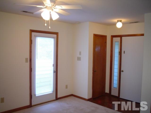 3247 Mill Run, Unit N/A Raleigh, NC 27612 - Photo 4 of 8 an empty room with chandelier fan