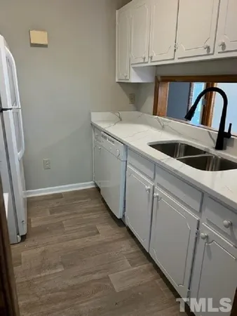 a kitchen with a sink and cabinets