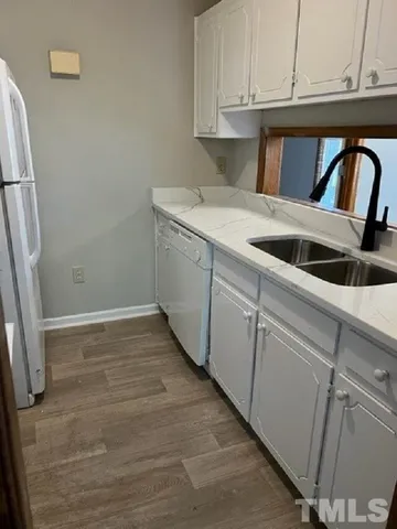 a kitchen with a sink and cabinets