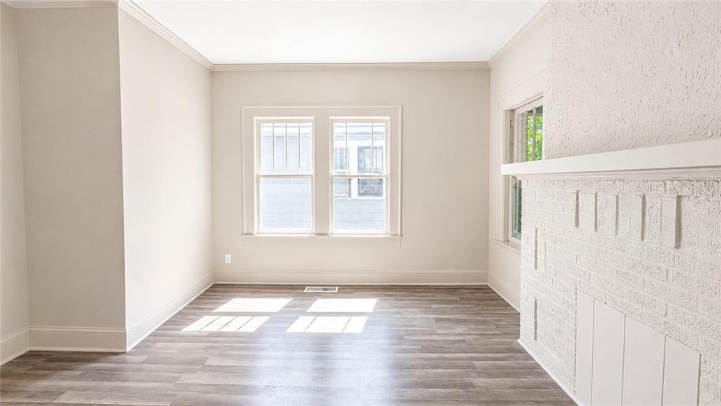 665 Lexington Avenue Southwest Atlanta, GA 30310 - Photo 10 of 33 a view of an empty room with wooden floor and a window