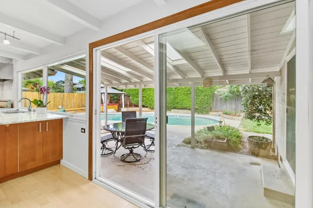 a view of a porch with chairs and backyard
