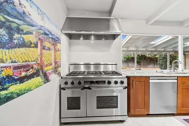a stove top oven sitting inside of a kitchen