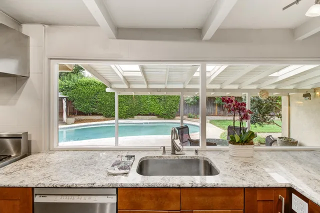 a kitchen with granite countertop a sink and a window