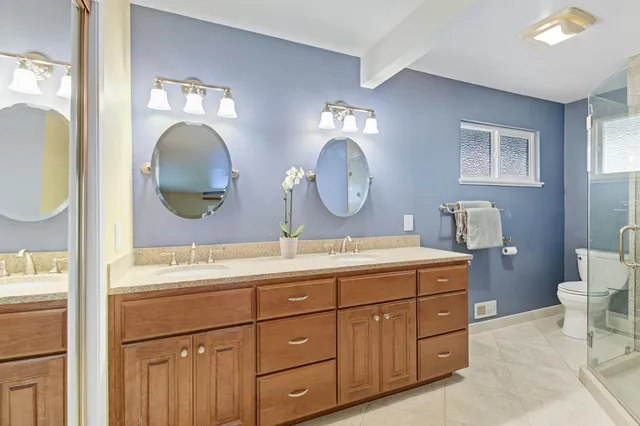 a bathroom with a double vanity sink and a mirror