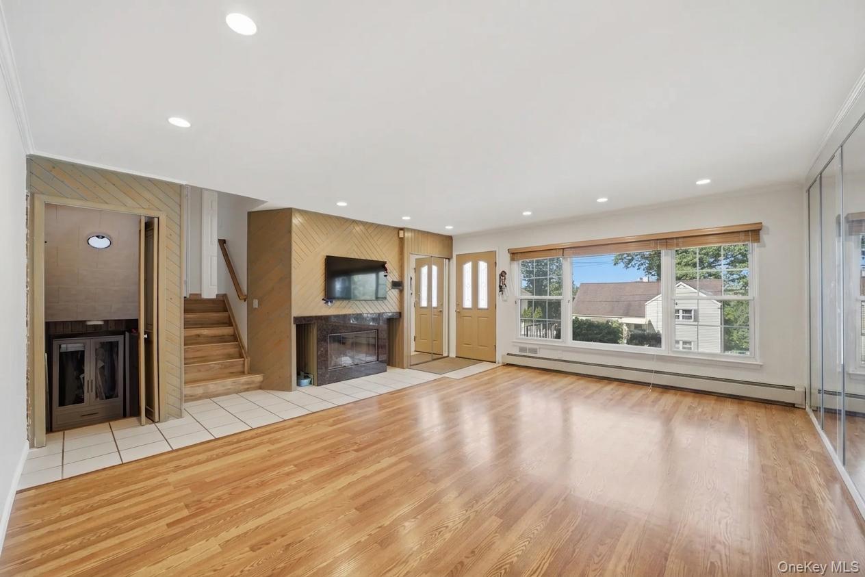 29 Montrose Road Yonkers, NY 10710 - Photo 5 of 39 Spacious living area featuring wood-finish flooring, recessed lighting, and a large picture window