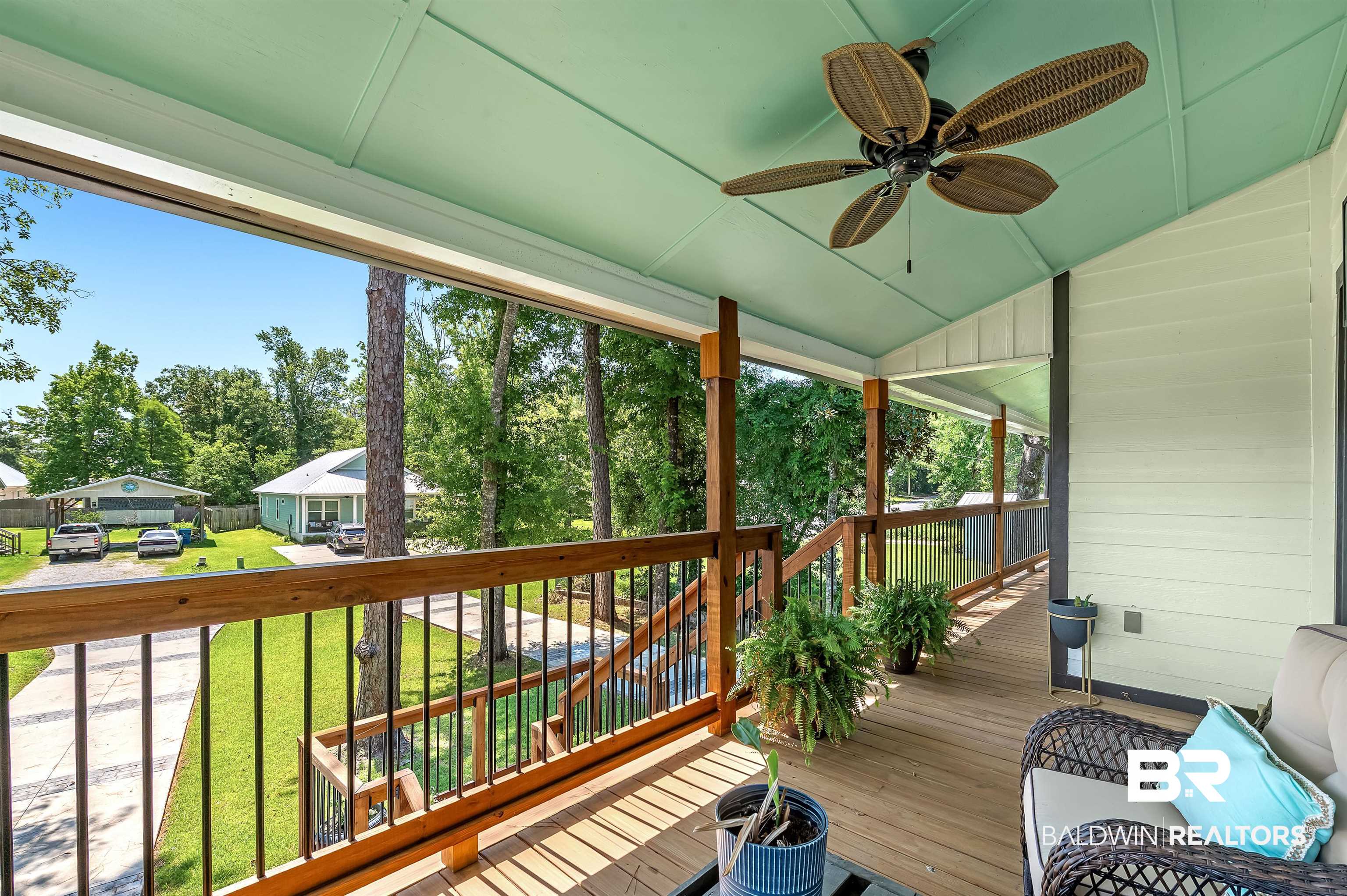 5215 Pine Road Orange Beach, AL 36561 - Photo 5 of 60 Deck with a ceiling fan and a yard