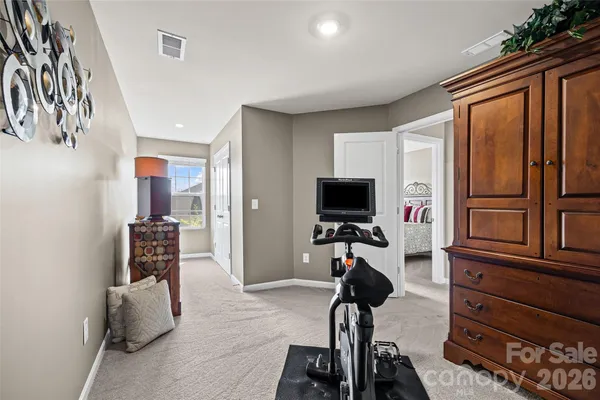 a room with gym equipment and white walls