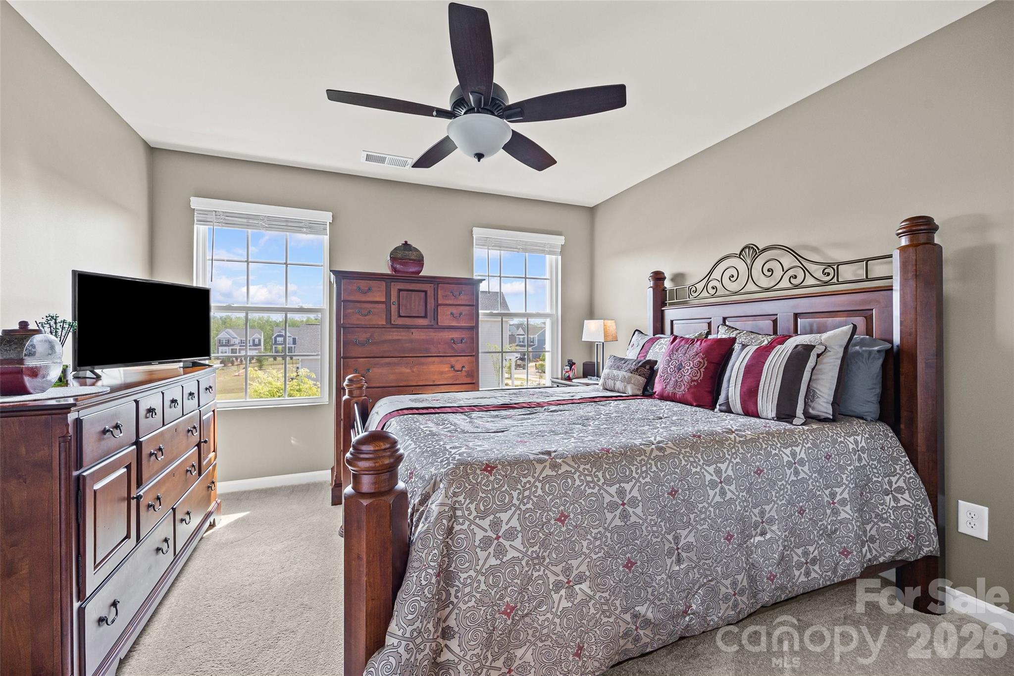 909 Cobbled Way Fort Mill, SC 29715 - Photo 15 of 31 a bedroom with a bed and a flat screen tv
