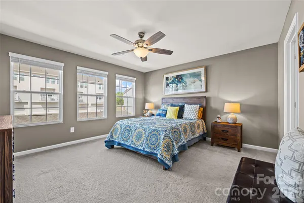 a spacious bedroom with a bed and a couch
