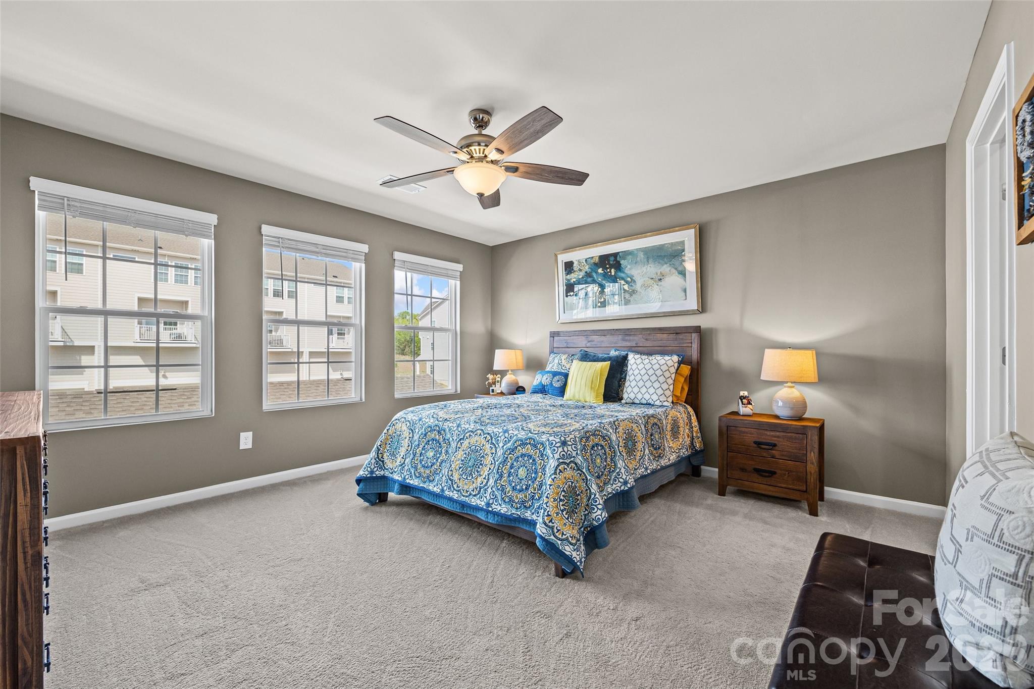 909 Cobbled Way Fort Mill, SC 29715 - Photo 19 of 31 a spacious bedroom with a bed and a chandelier