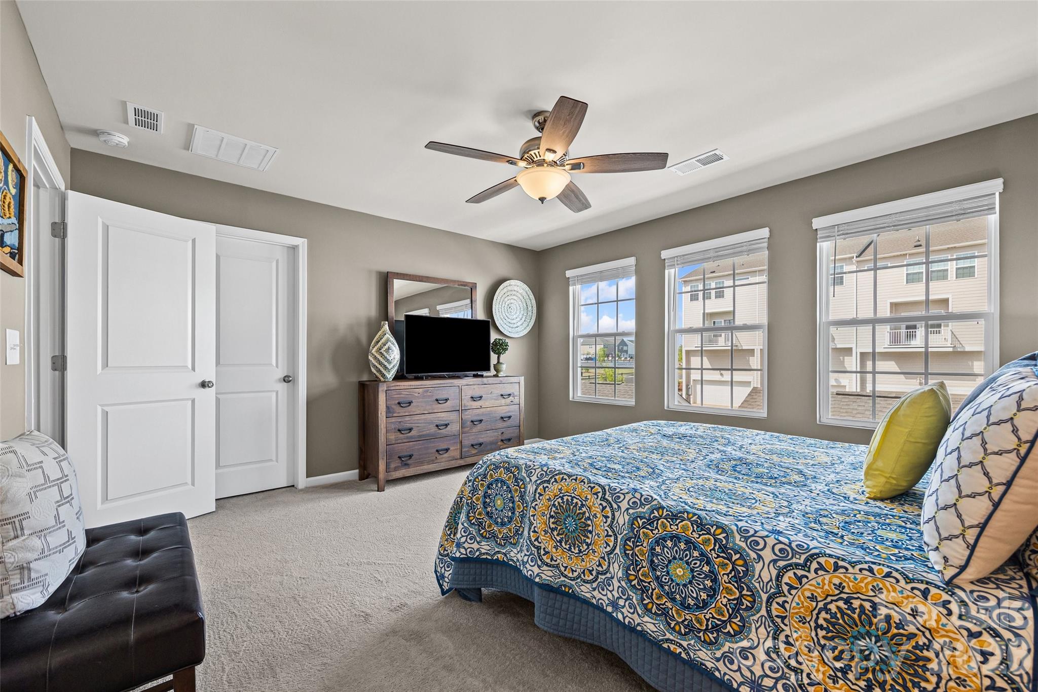 909 Cobbled Way Fort Mill, SC 29715 - Photo 20 of 31 a spacious bedroom with a bed and a couch
