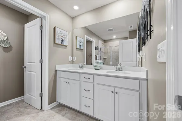 a bathroom with a glass shower door