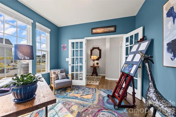 a kitchen with stainless steel appliances kitchen island granite countertop a table chairs sink and cabinets