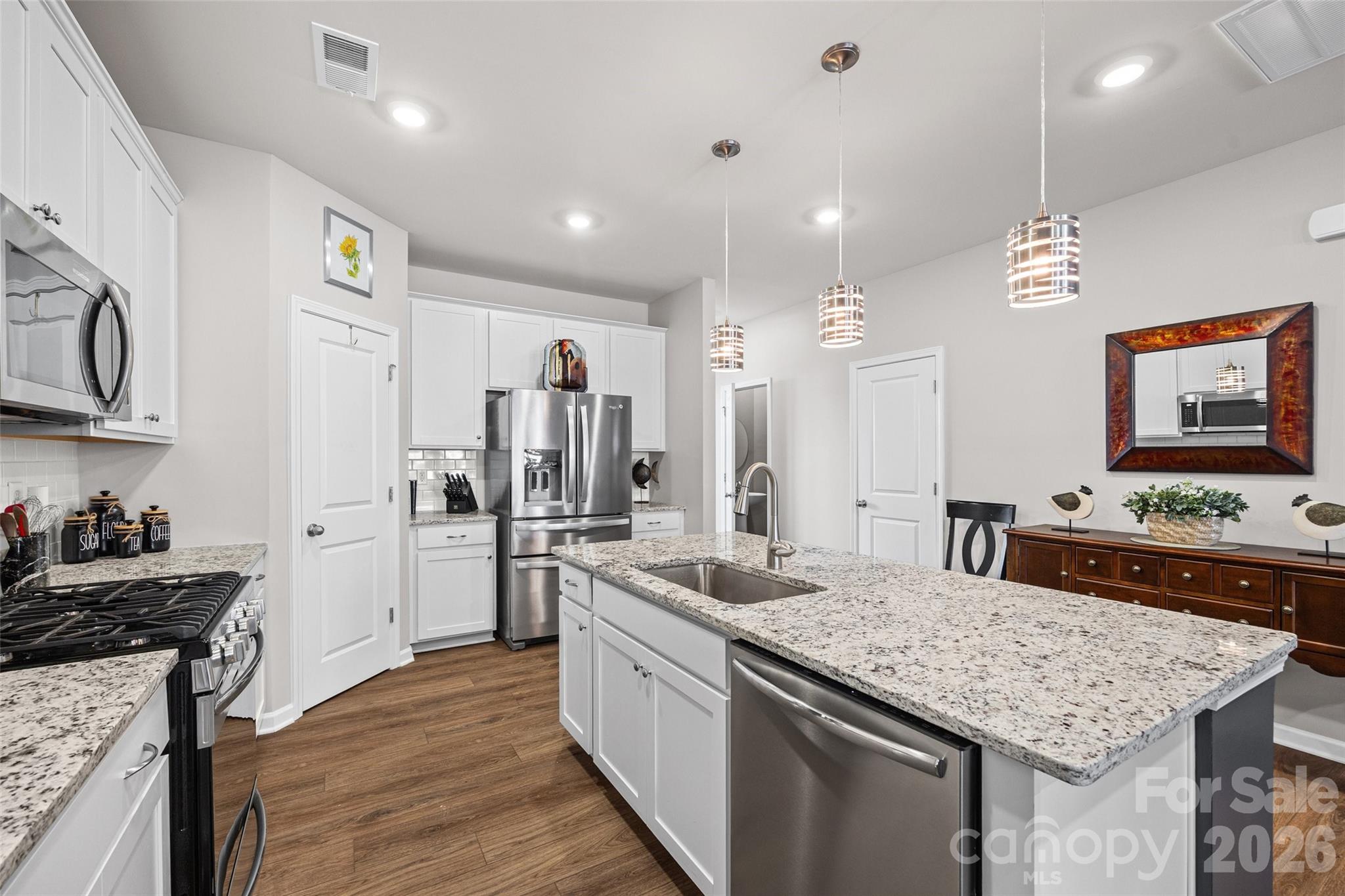 909 Cobbled Way Fort Mill, SC 29715 - Photo 7 of 31 a kitchen with stainless steel appliances granite countertop a sink stove and refrigerator