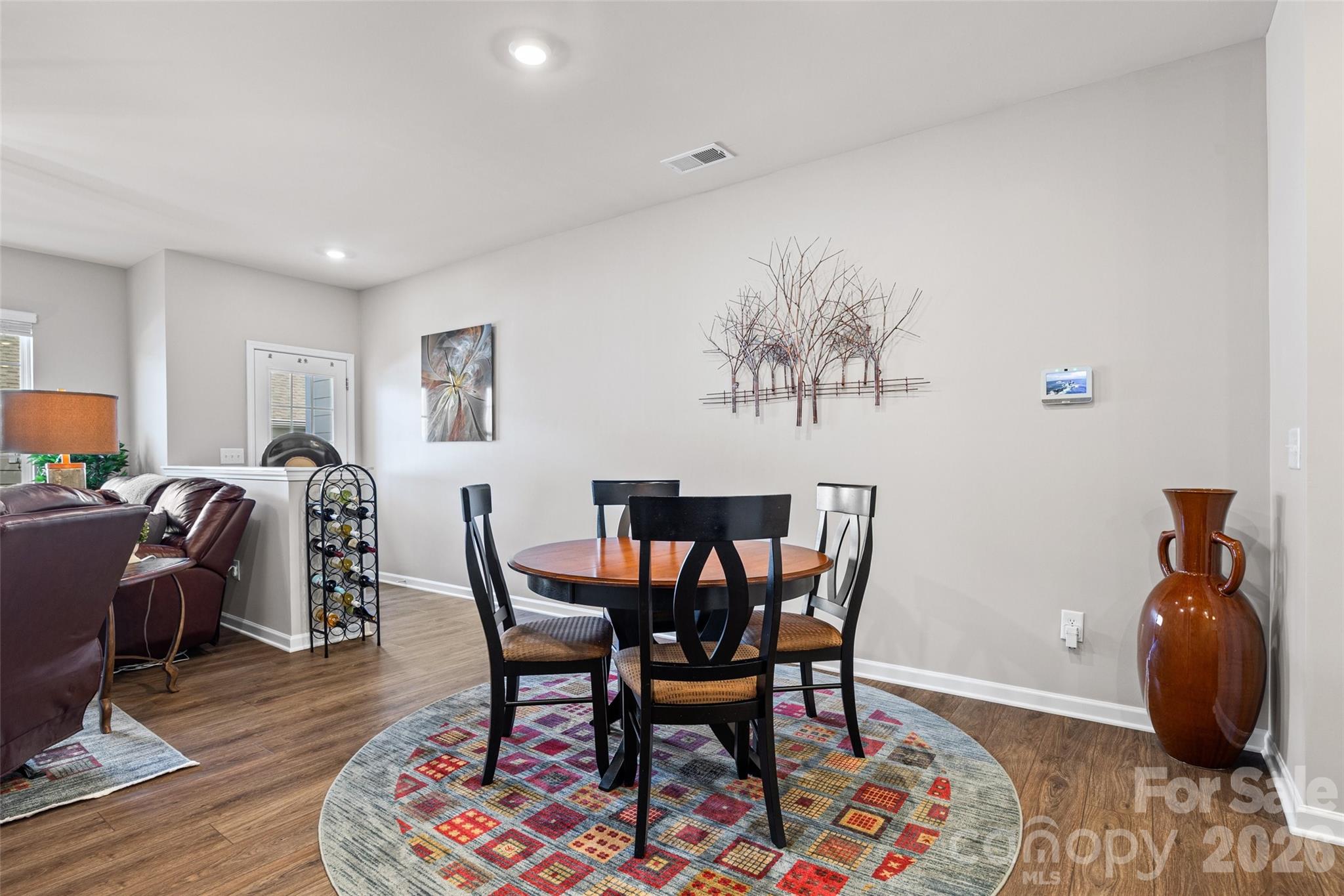 909 Cobbled Way Fort Mill, SC 29715 - Photo 8 of 31 a view of a dining room with furniture and wooden floor