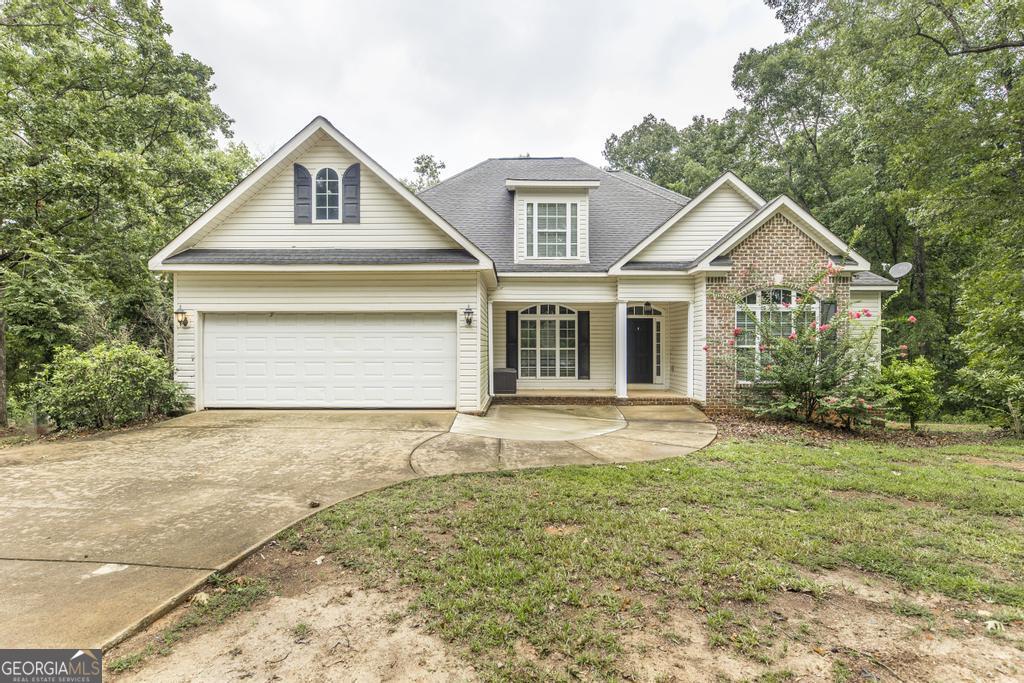 408 Railroad Street Gray, GA 31032 - Photo 1 of 1 a front view of a house with a garden and yard