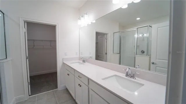 a bathroom with a double vanity sink mirror and double