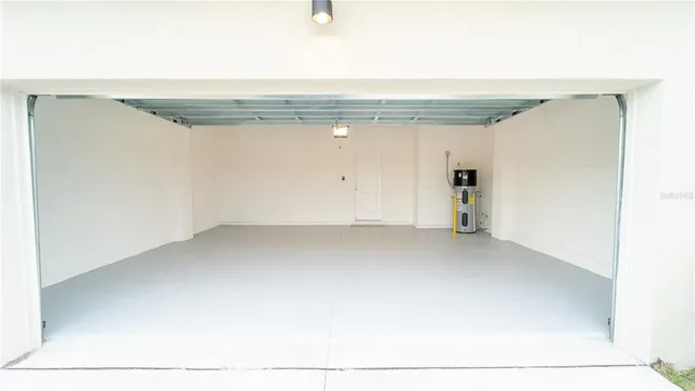a kitchen with a refrigerator sink and cabinets