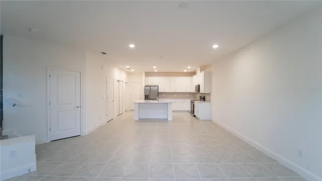 a view of a kitchen with a sink and a refrigerator
