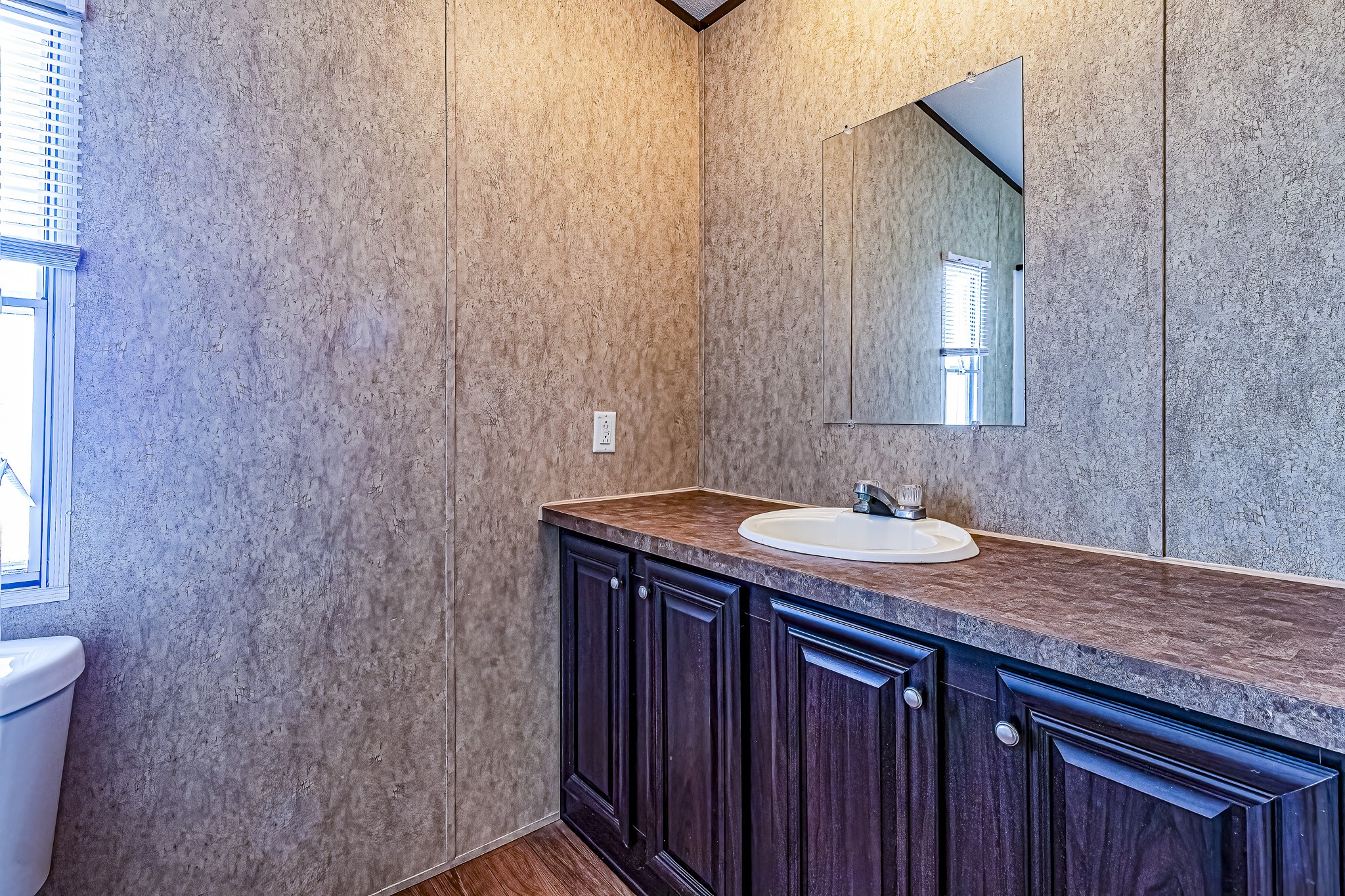 210 Rain Forest Road Onalaska, TX 77360 - Photo 16 of 26 a bathroom with a granite countertop sink and mirror