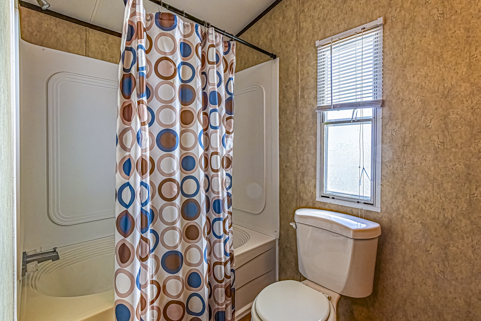 210 Rain Forest Road Onalaska, TX 77360 - Photo 17 of 26 a white toilet sitting next to a bathroom sink
