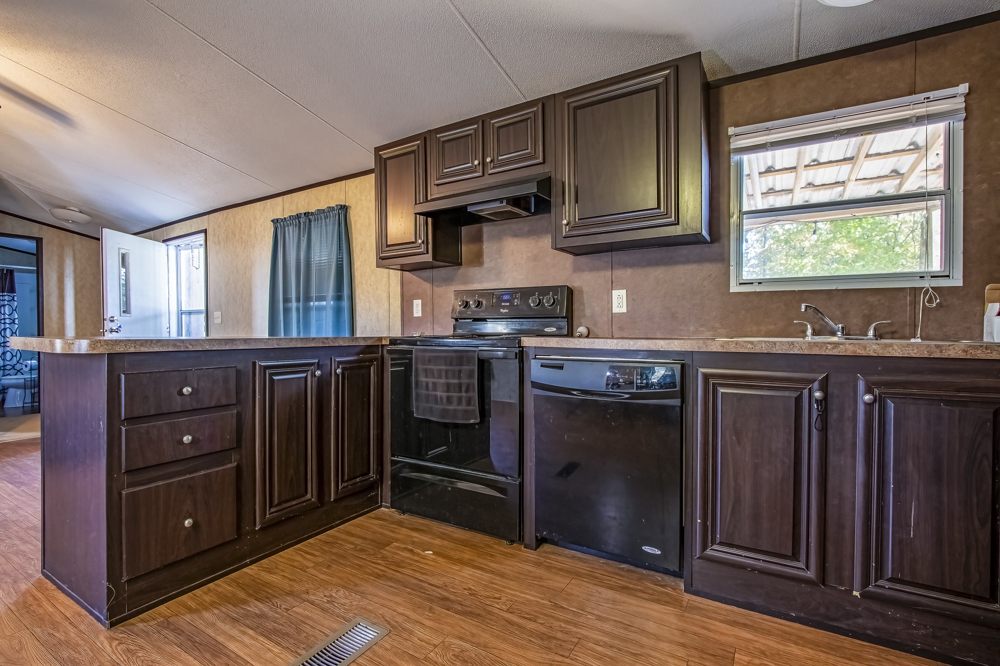 210 Rain Forest Road Onalaska, TX 77360 - Photo 20 of 26 a kitchen with stainless steel appliances granite countertop a stove a sink dishwasher and a refrigerator