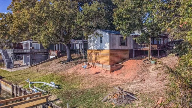 a view of a house with backyard and sitting area
