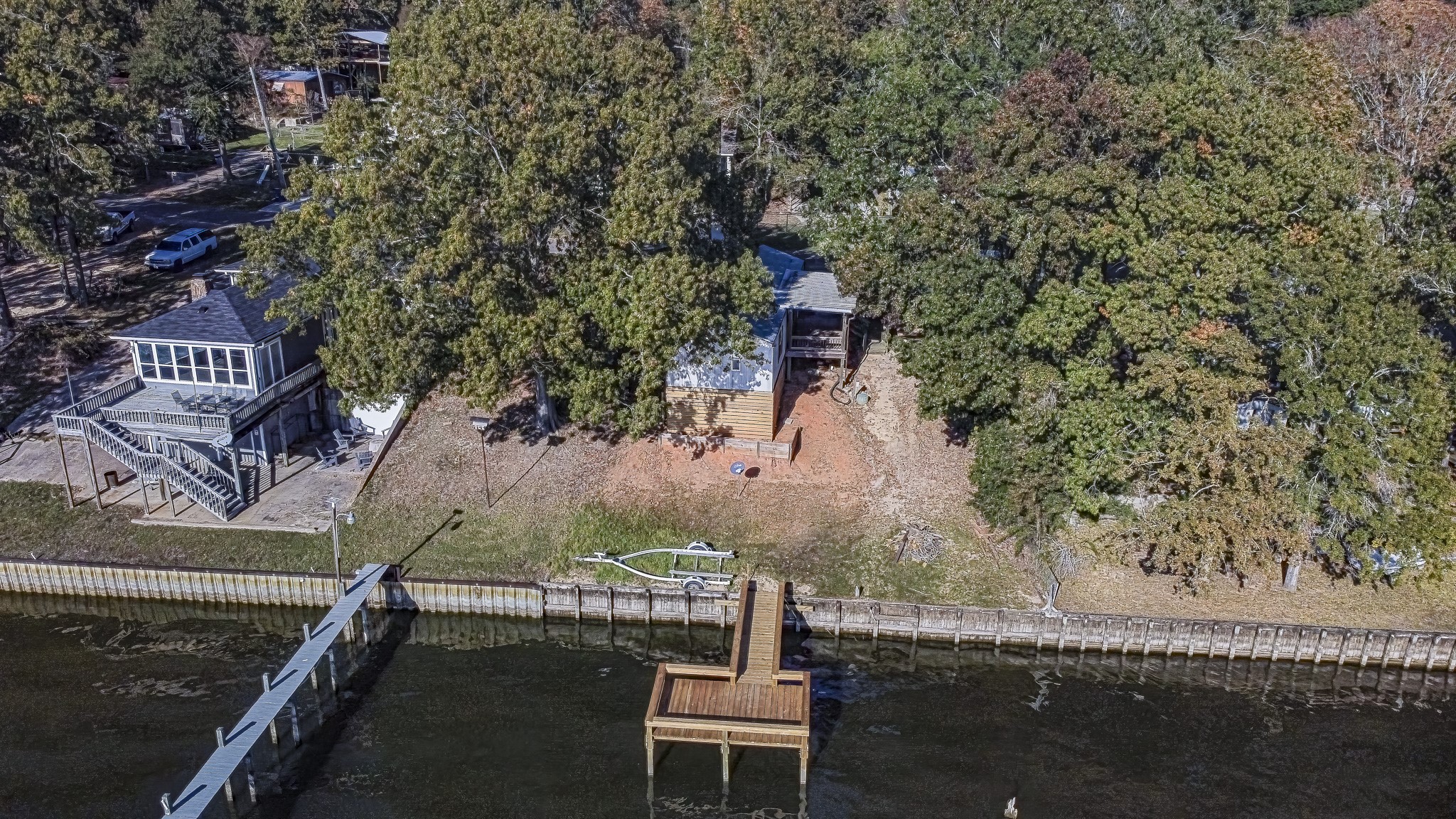 210 Rain Forest Road Onalaska, TX 77360 - Photo 10 of 26 a wooden bench sitting in backside of a house