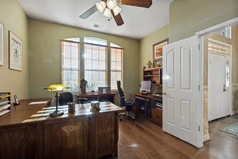 a spacious bathroom with double vanity and a large mirror