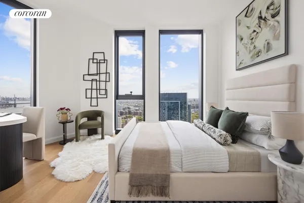 a bedroom with a bed and a large window