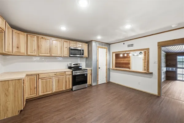a kitchen with stainless steel appliances granite countertop a stove a sink and a refrigerator