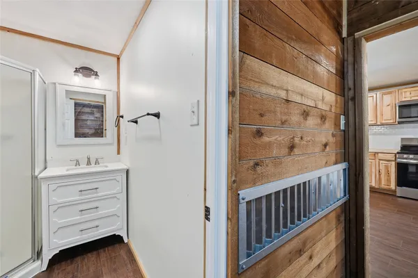 a view of a hallway with closet and wooden floor