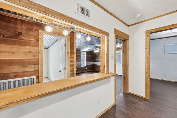 a bedroom with a bed and a large window with wooden floor